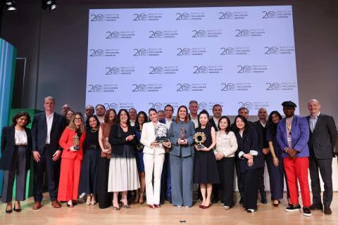 Winners of the 2026 L’Oréal Beauty of Inclusion Awards, alongside ExCom members and CEO Nicolas Hieronimus, posing on stage with their trophies in front of a backdrop reading '20 Years of L'Oréal Diversity Equity & Inclusion | Beauty of Inclusion Awards’. 